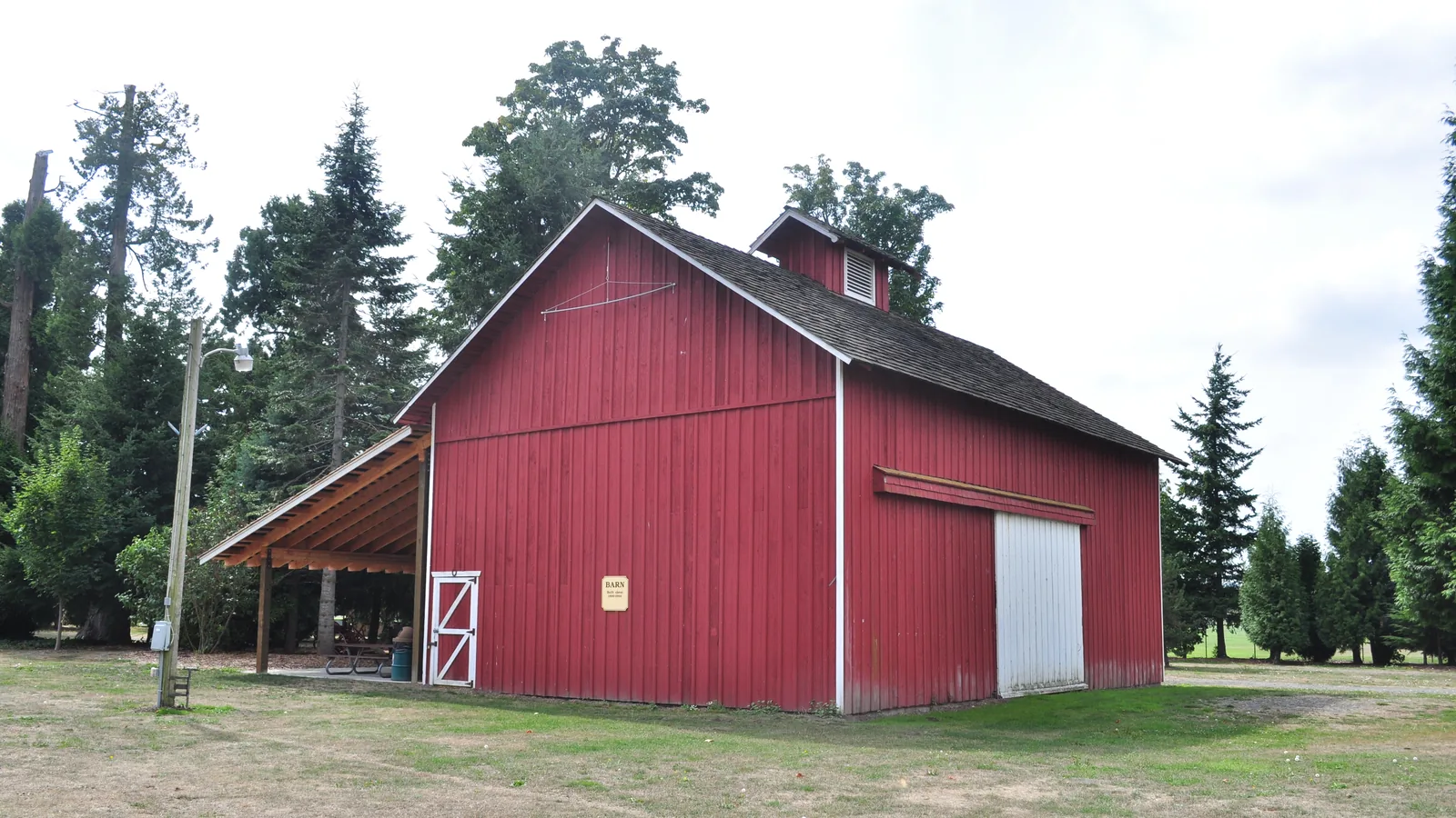 The weathered Barr Barn at Pioneer Park in Ferndale, with a cupola and a small window near the roof.