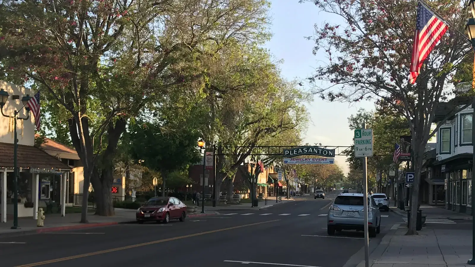 Main Street in downtown Pleasanton, with angled parking and two-story storefronts.