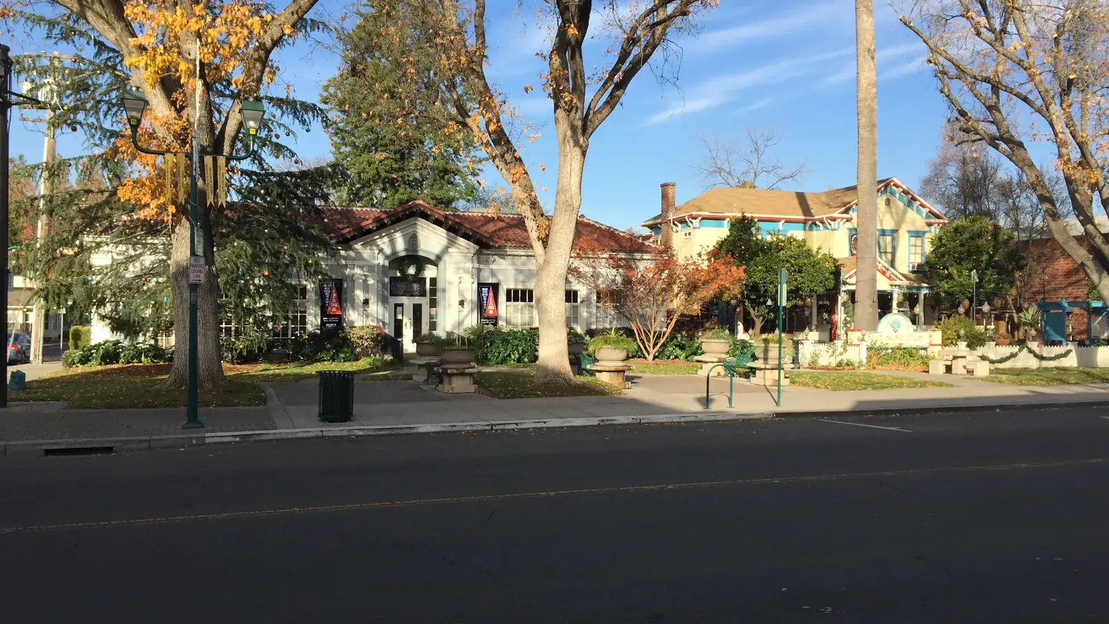 Museum on Main in Pleasanton, a yellow Victorian house beside a brick building.