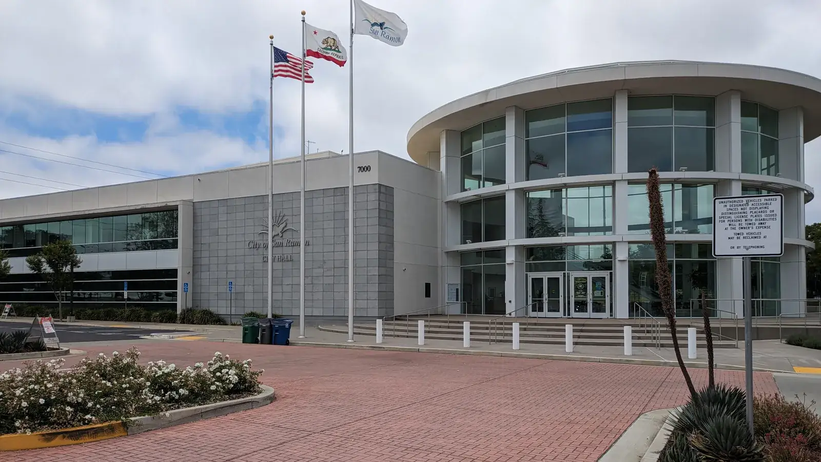 San Ramon City Hall, a curved concrete building with a reflecting pool and Mount Diablo behind it.